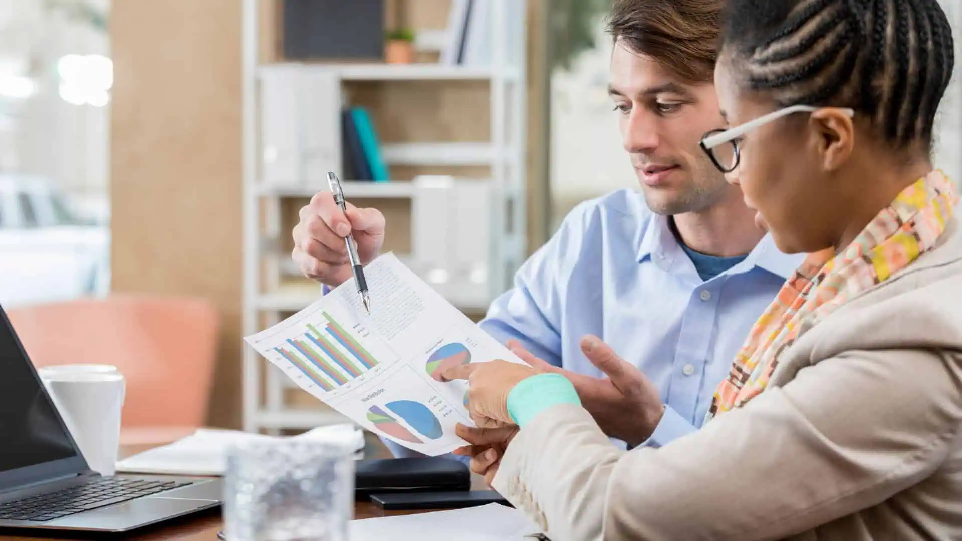 Accountants reviewing financial charts for outsourced accounting services.